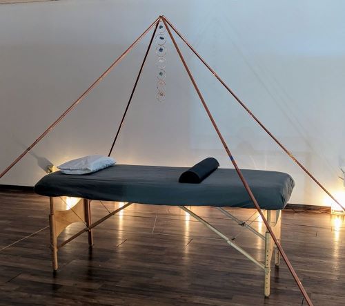 Copper Giza Pyramid with a massage table prepared for a Reiki healing session at Prana Blessings Metaphysical Shop.
